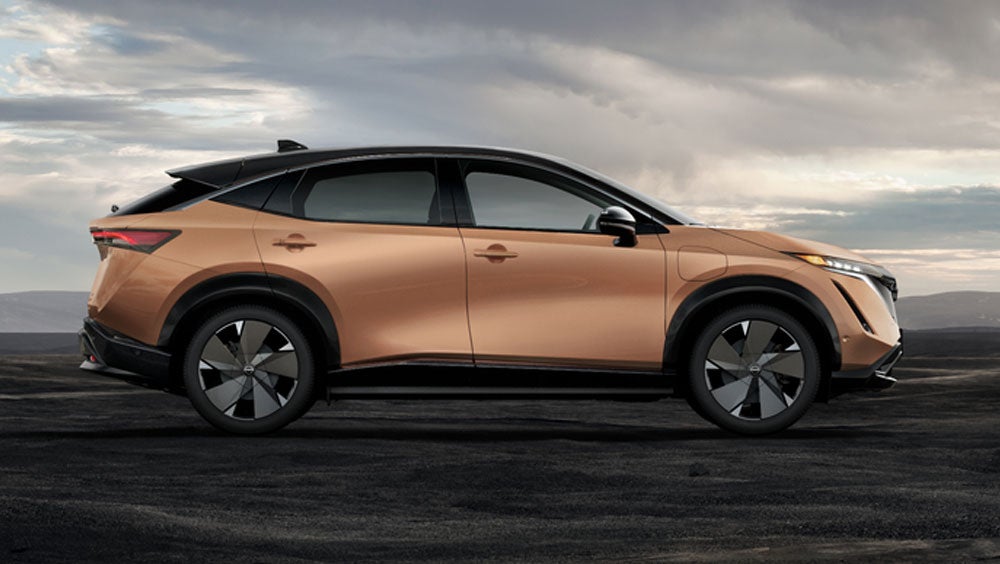 Nissan ARIYA in Sunrise Copper in dramatic landscape | Nissan of Picayune in Picayune MS